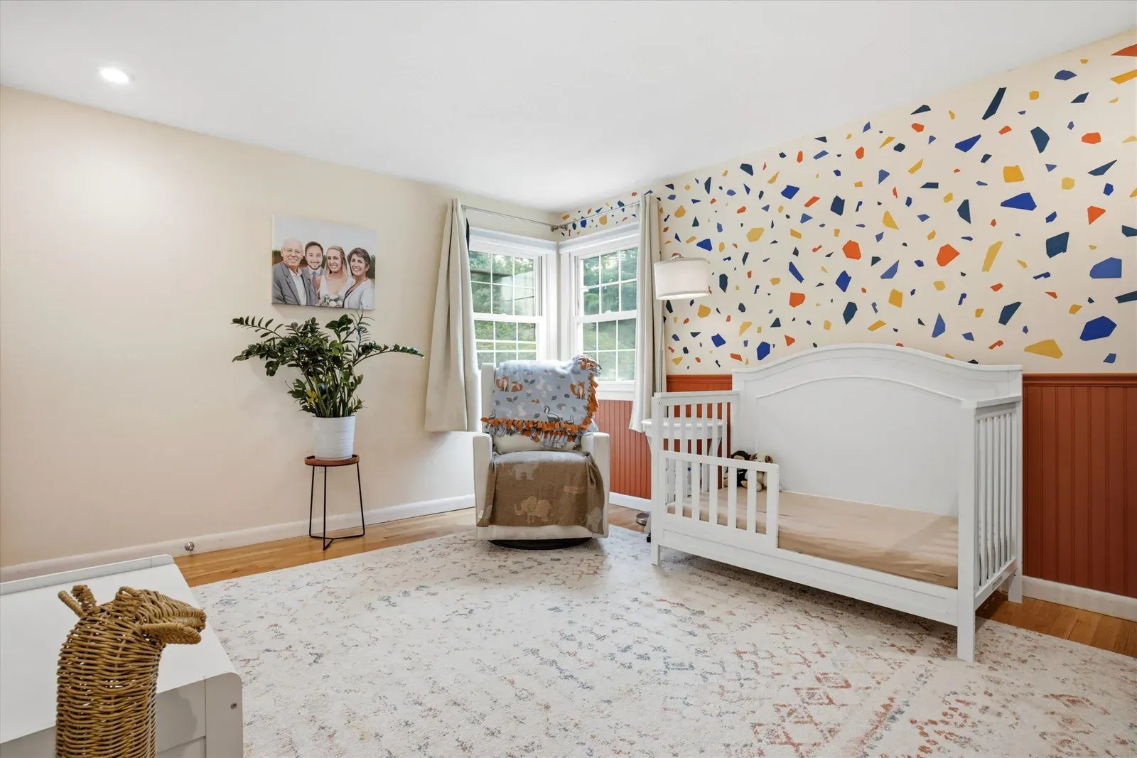 Bedroom with crib and patterned accent wall at 14 Bloomingdale Drive