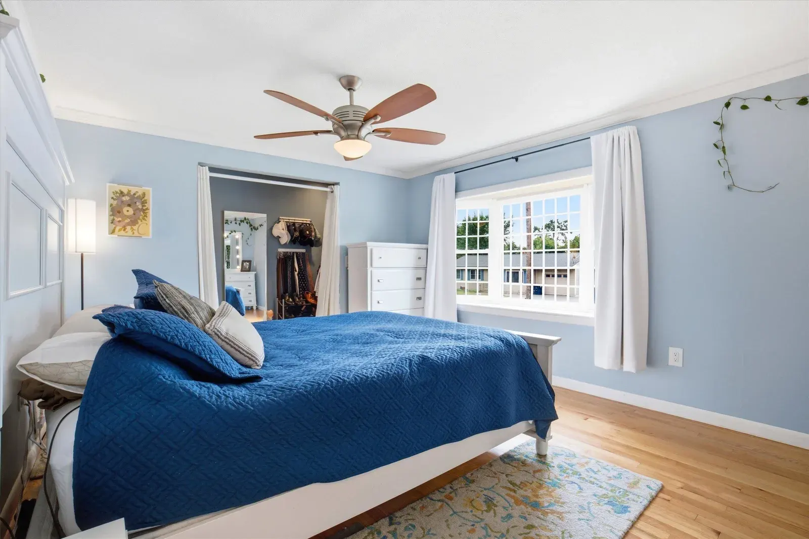 Bedroom with ceiling fan and blue bedding at 14 Bloomingdale Drive