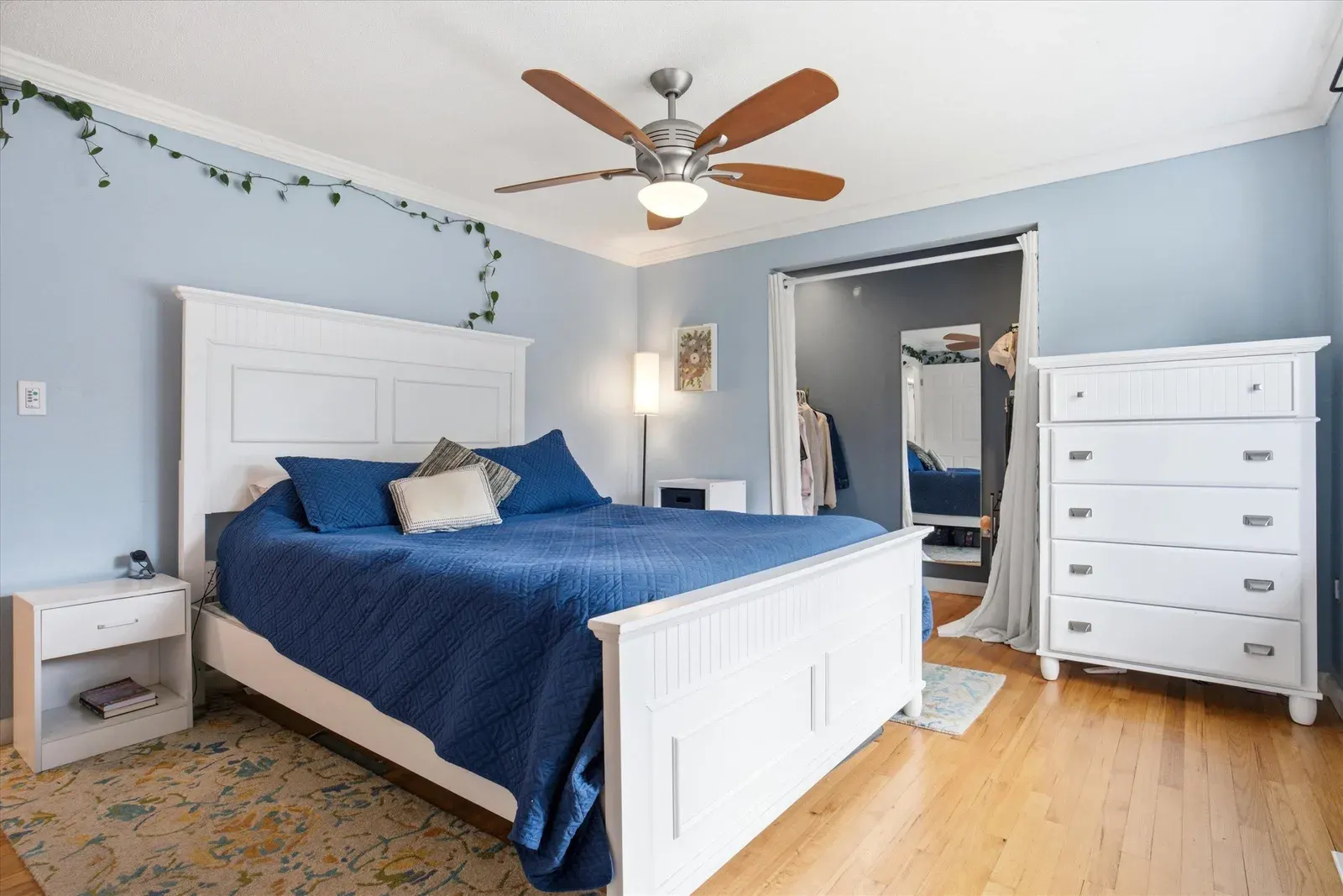 Bedroom with dresser and two windows at 14 Bloomingdale Drive