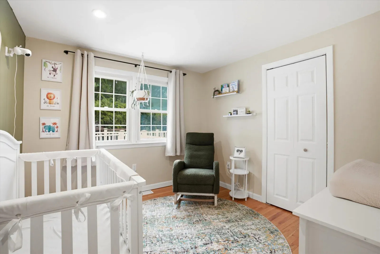 Bedroom with crib and corner windows at 14 Bloomingdale Drive