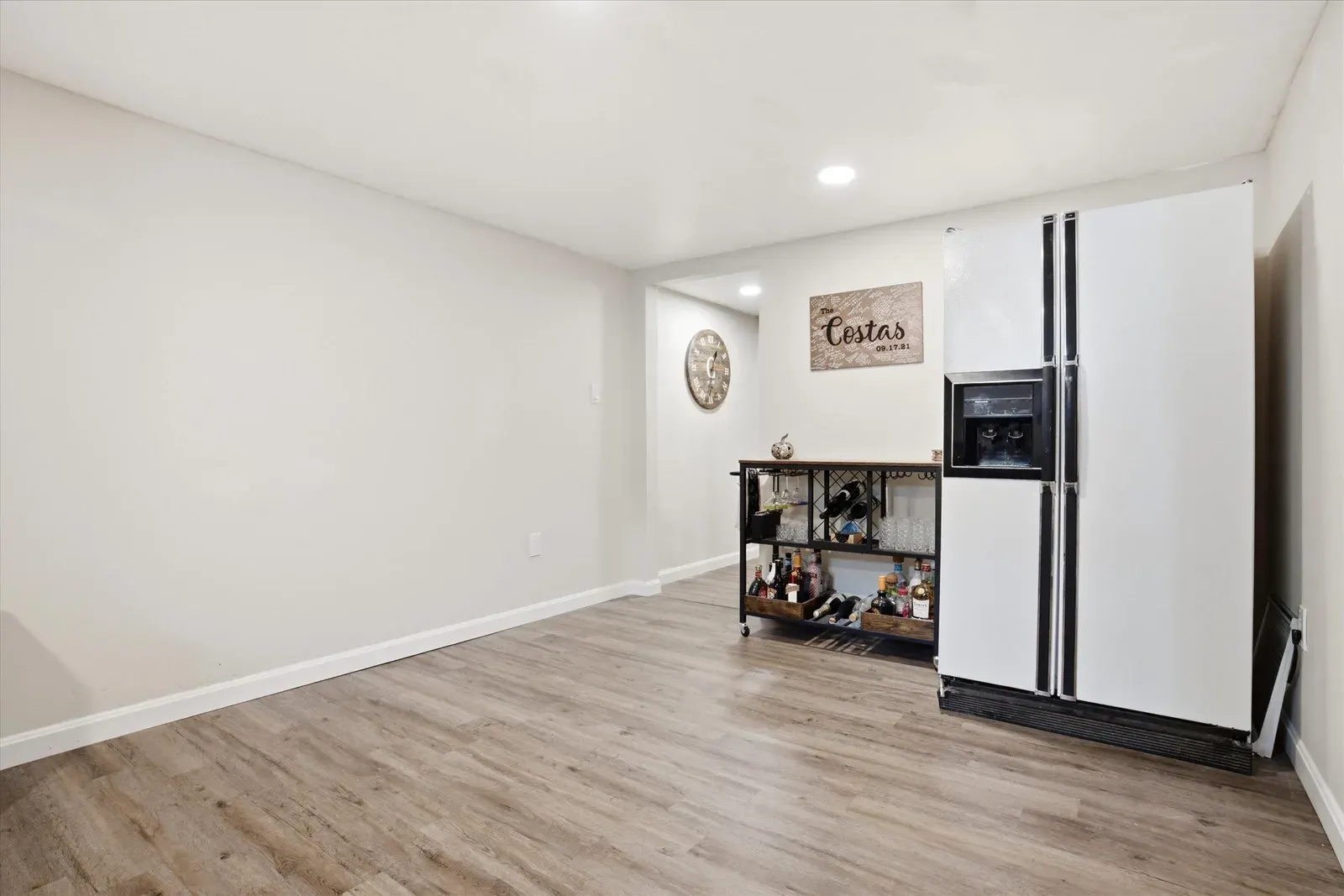 Lower-level stairs and refrigerator at 14 Bloomingdale Drive