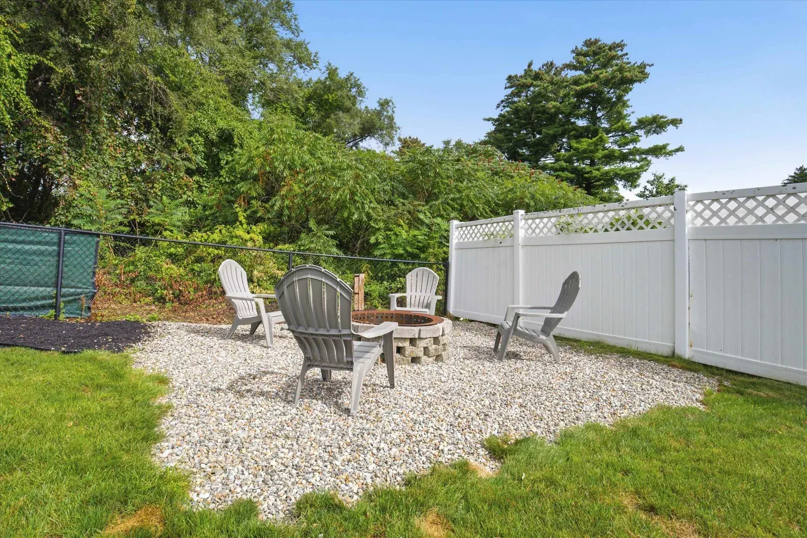 Backyard fire pit seating area at 14 Bloomingdale Drive