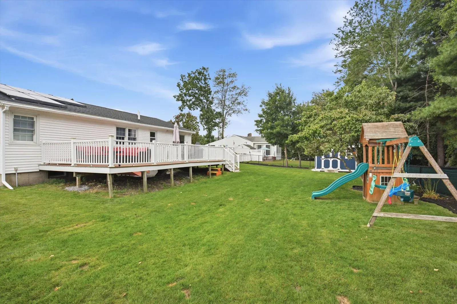 Fenced backyard with play area at 14 Bloomingdale Drive