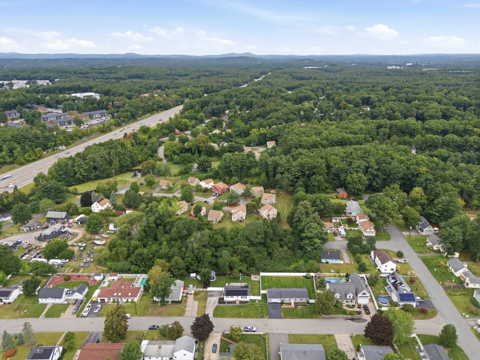 Aerial neighborhood view toward the highway at 14 Bloomingdale Drive