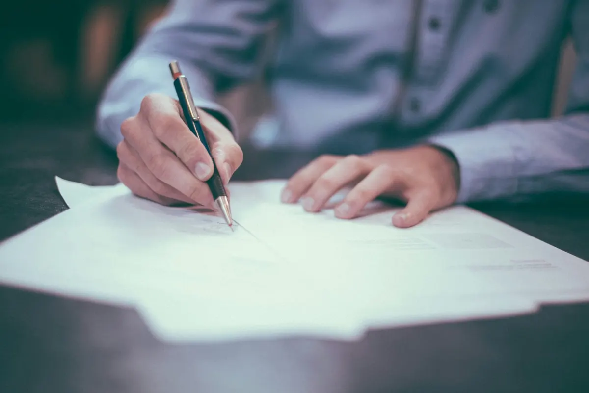 Home buyer signing real estate documents at a table