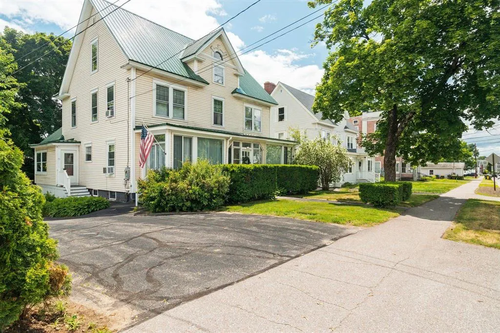 Historic New England home with an American flag