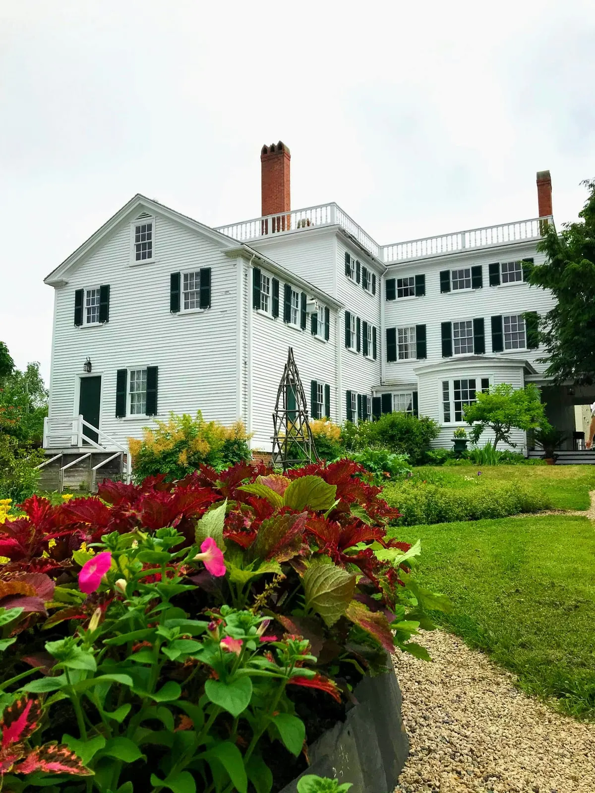 Historic New England home with landscaped grounds