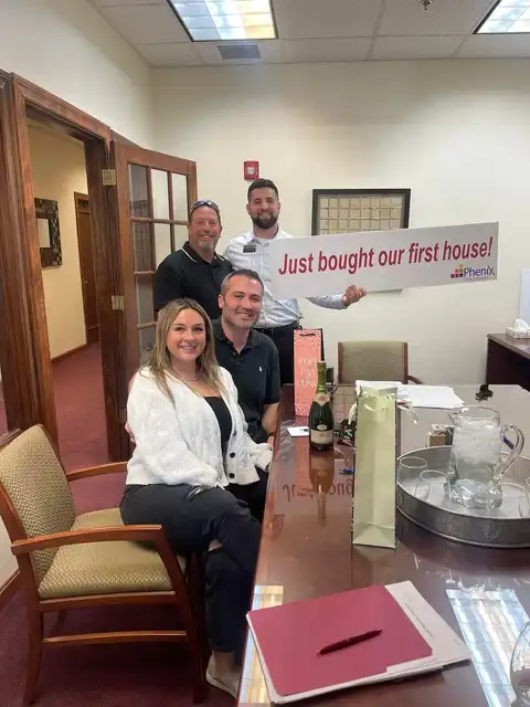 Tyler Costa celebrating with first-time homebuyers after closing